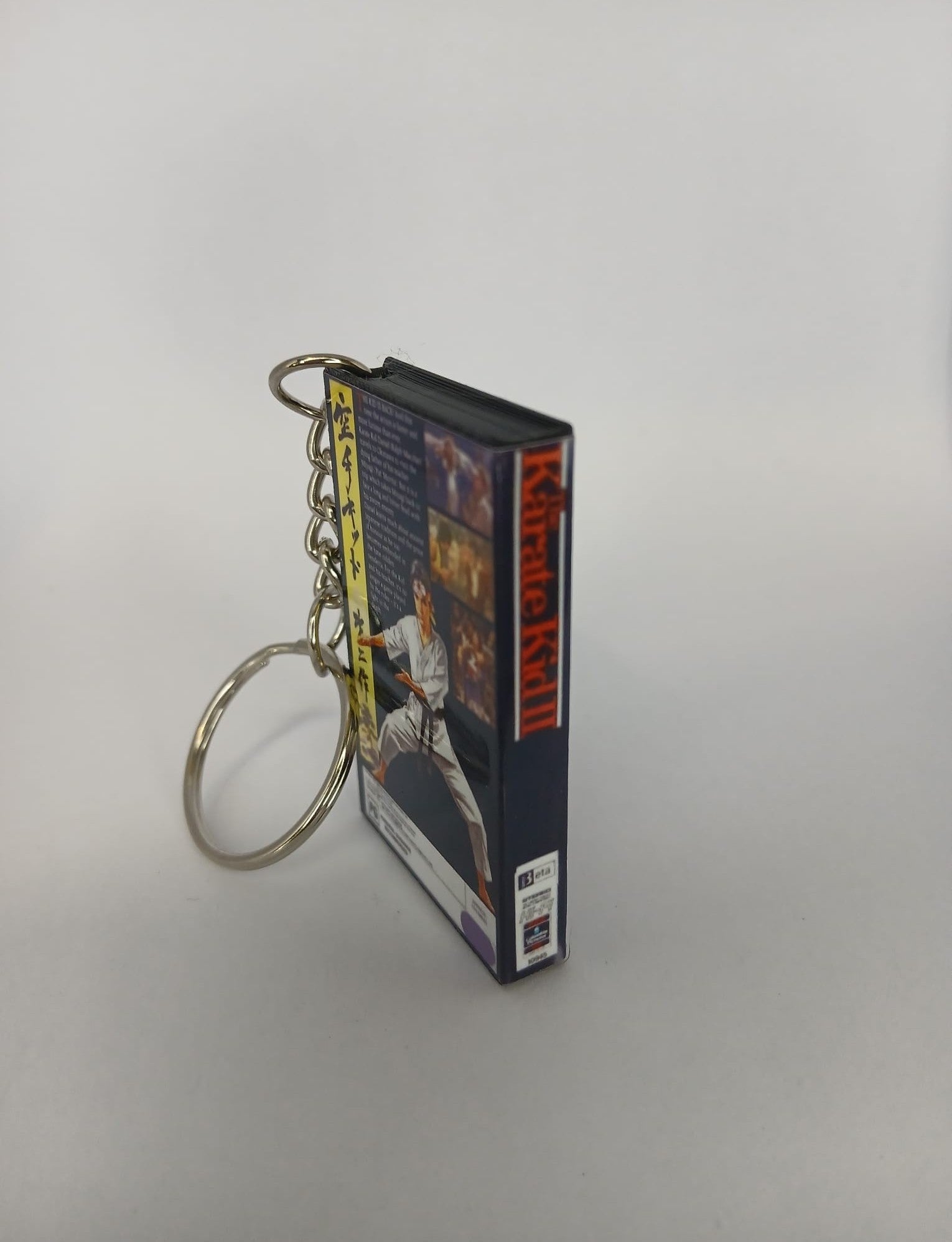 The Karate Kid Part II VHS keyring — flat lay front and back angled