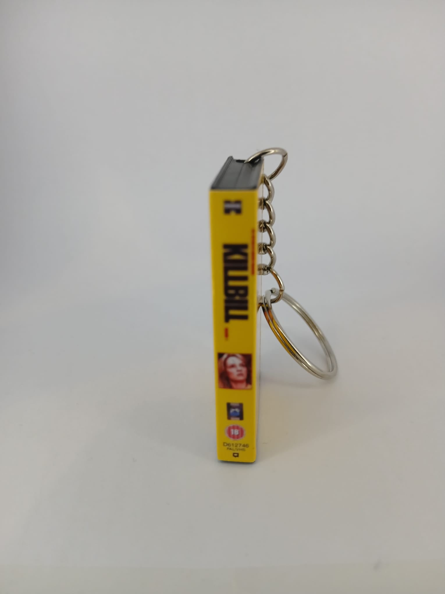 Kill Bill Volume 1 VHS keyring — back cover angled view standing