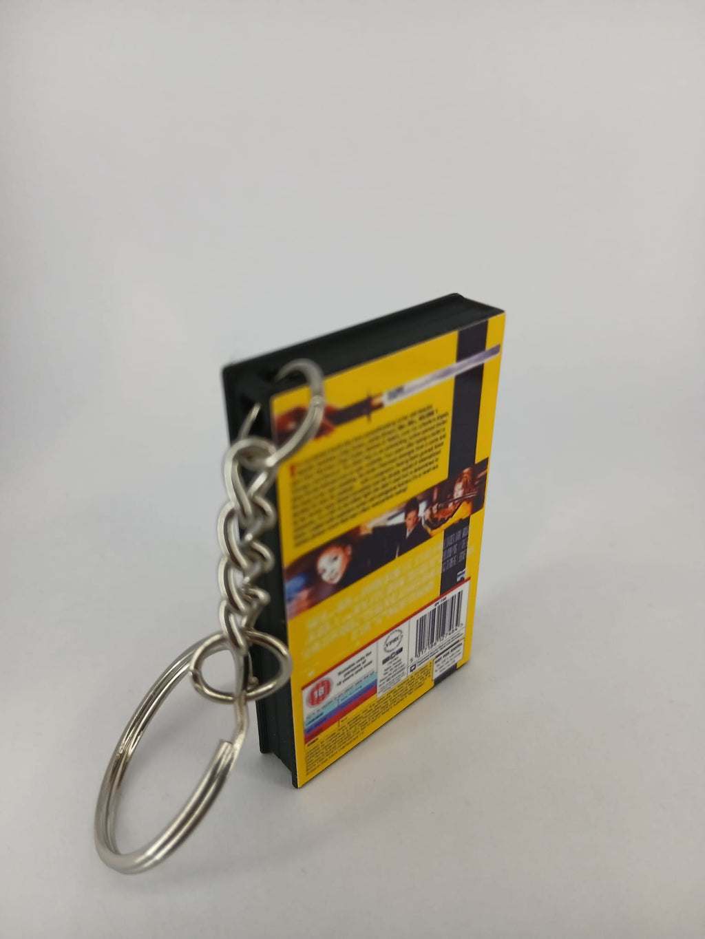 Kill Bill Volume 1 VHS keyring — spine and back angled view standing