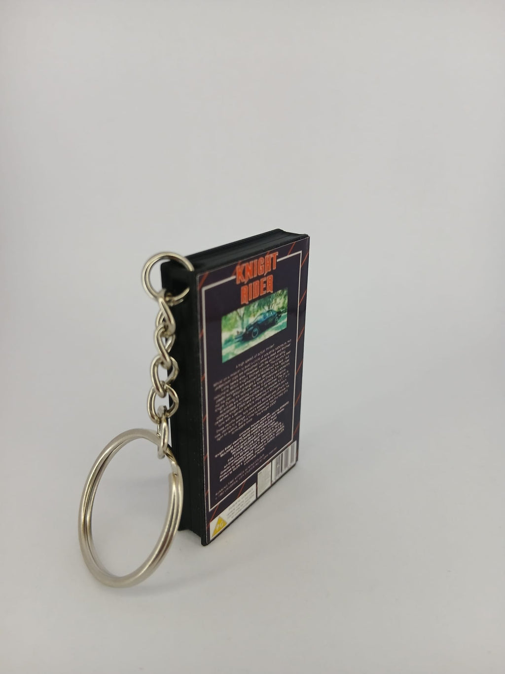 Knight Rider VHS keyring — back and spine angled view standing