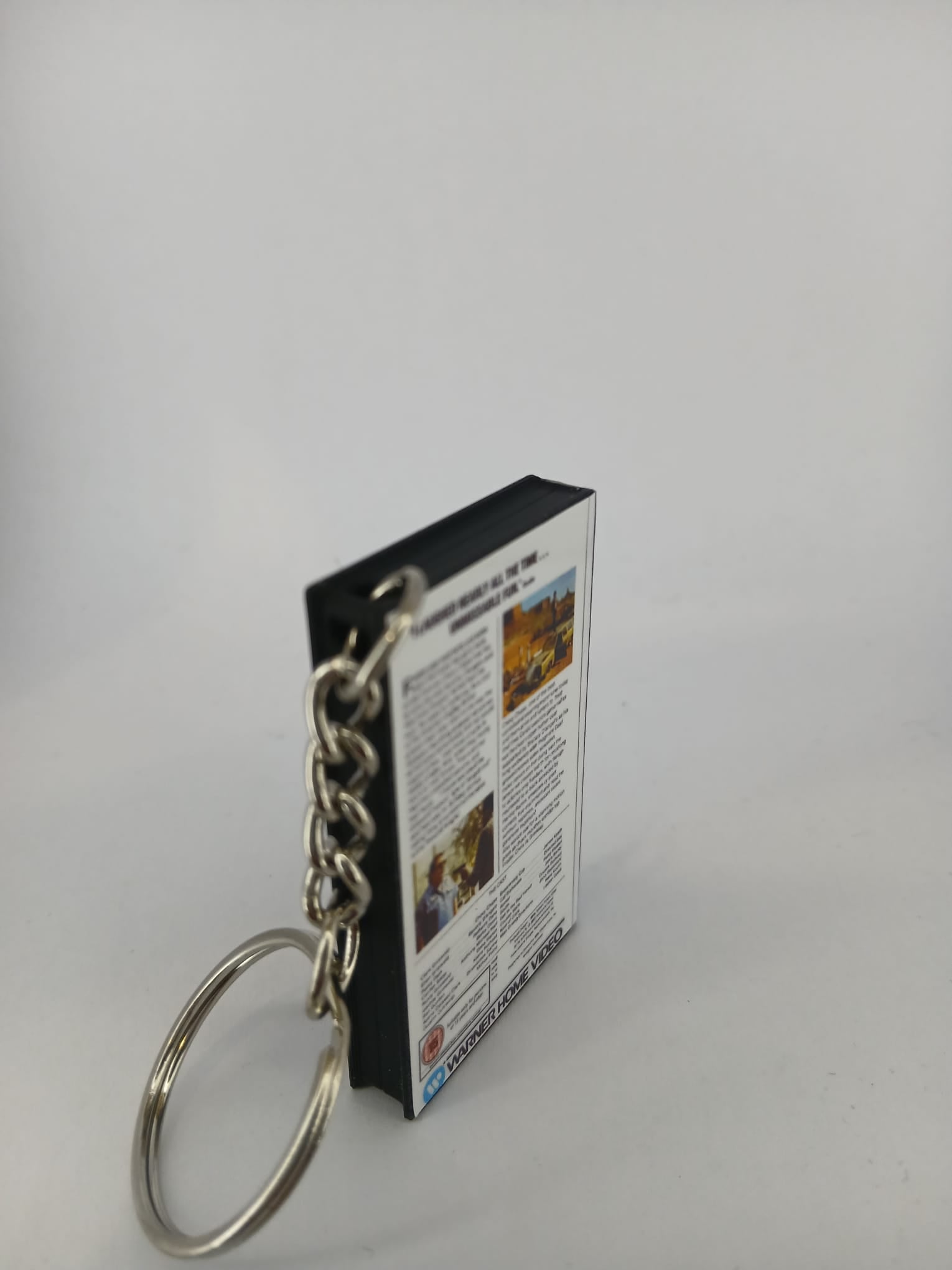 National Lampoon's Vacation VHS keyring — flat lay front and spine angled