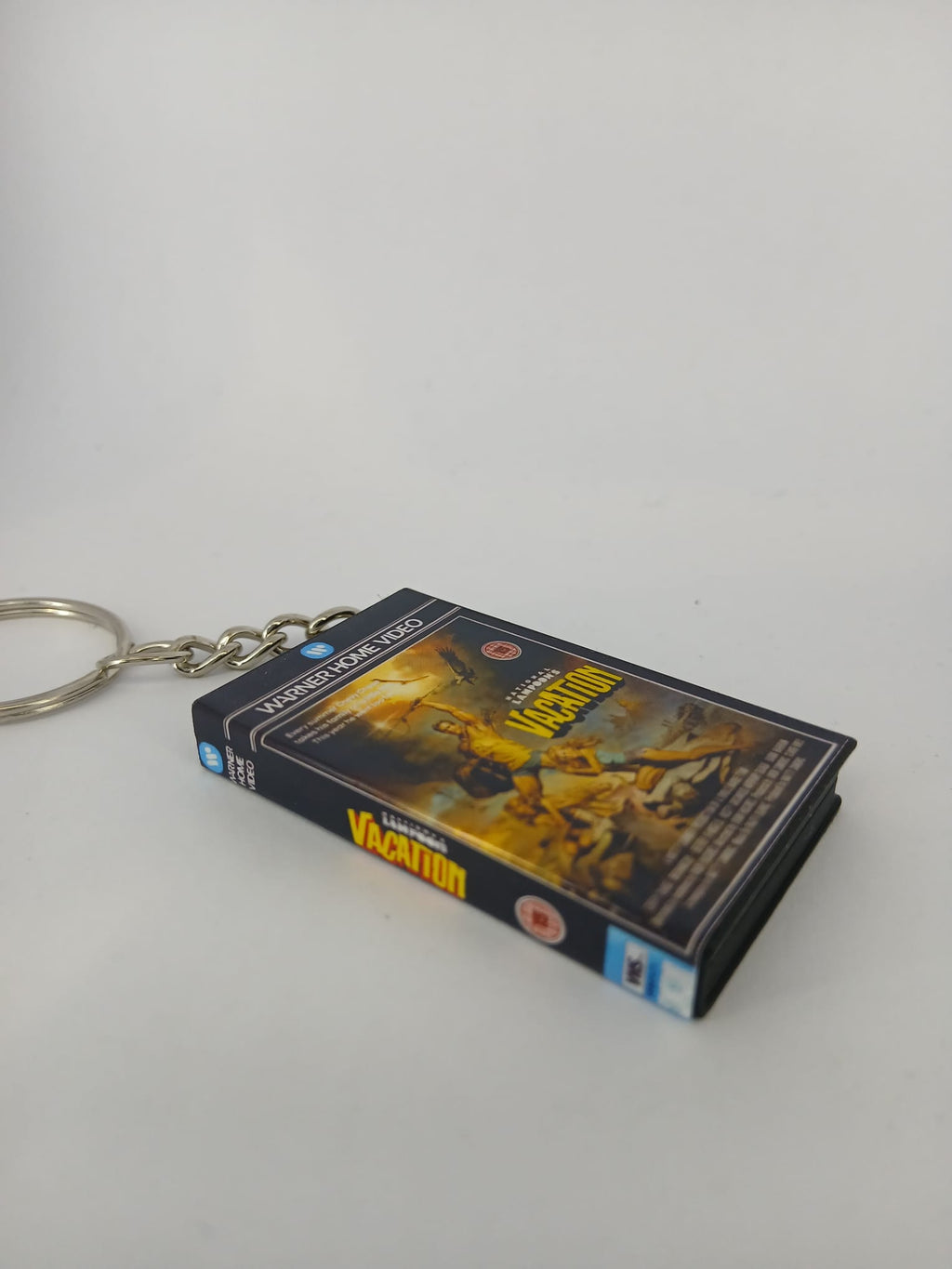 National Lampoon's Vacation VHS keyring — back cover standing angled