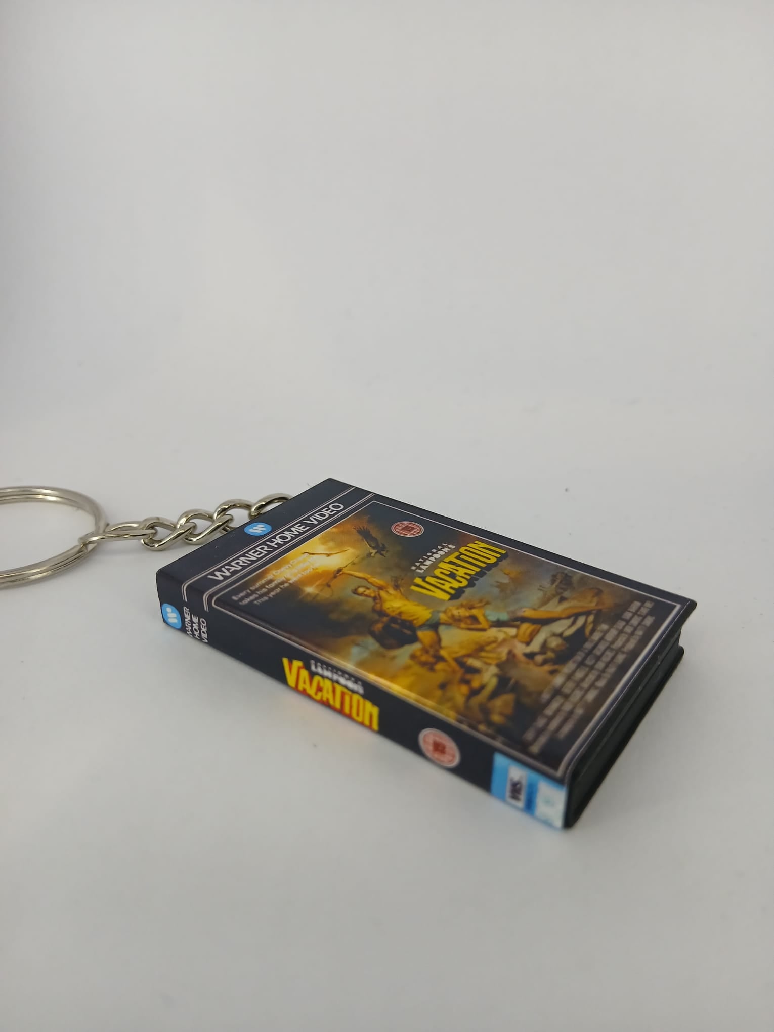 National Lampoon's Vacation VHS keyring — back cover standing angled