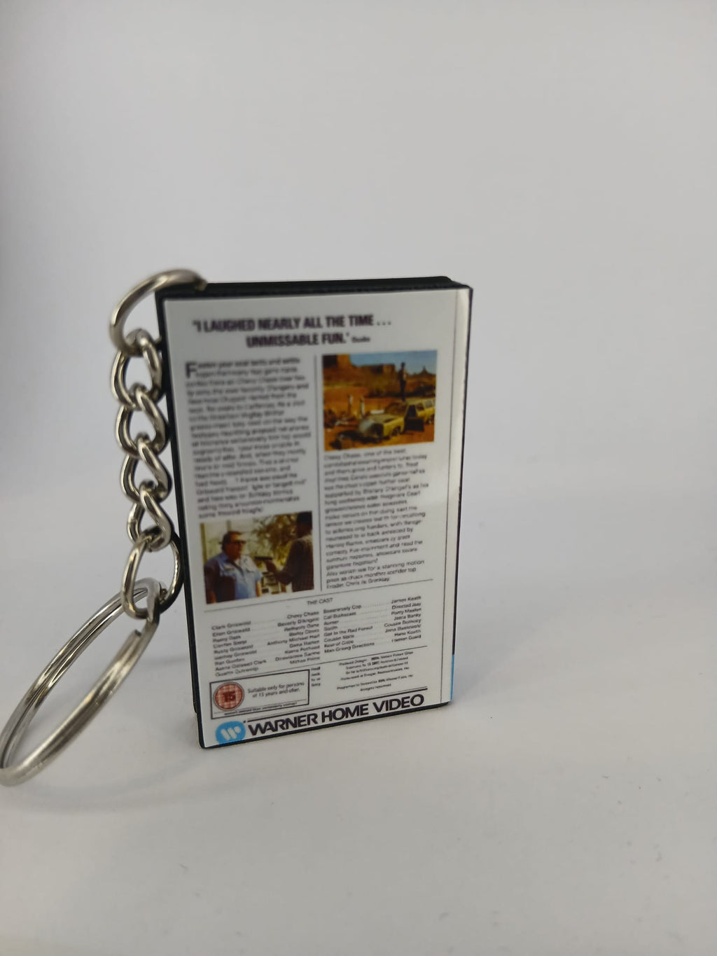 National Lampoon's Vacation VHS keyring — back and spine angled view standing