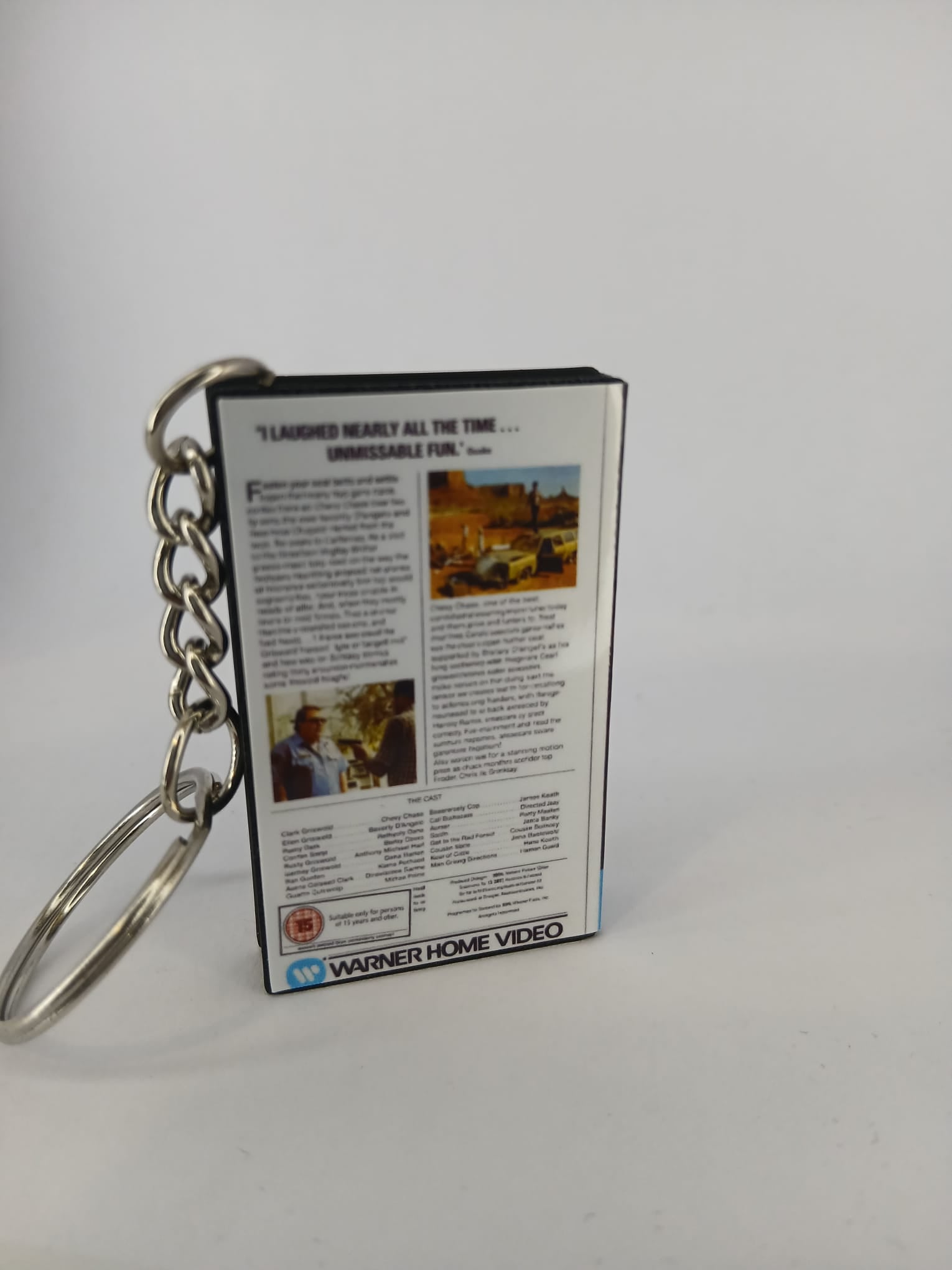 National Lampoon's Vacation VHS keyring — back and spine angled view standing