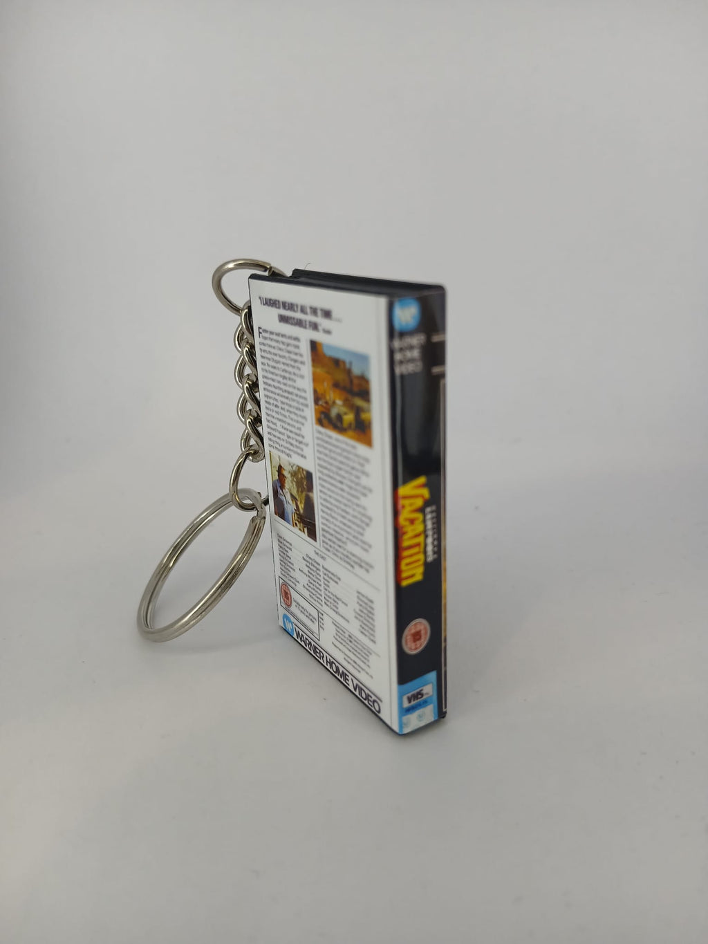 National Lampoon's Vacation VHS keyring — spine view standing
