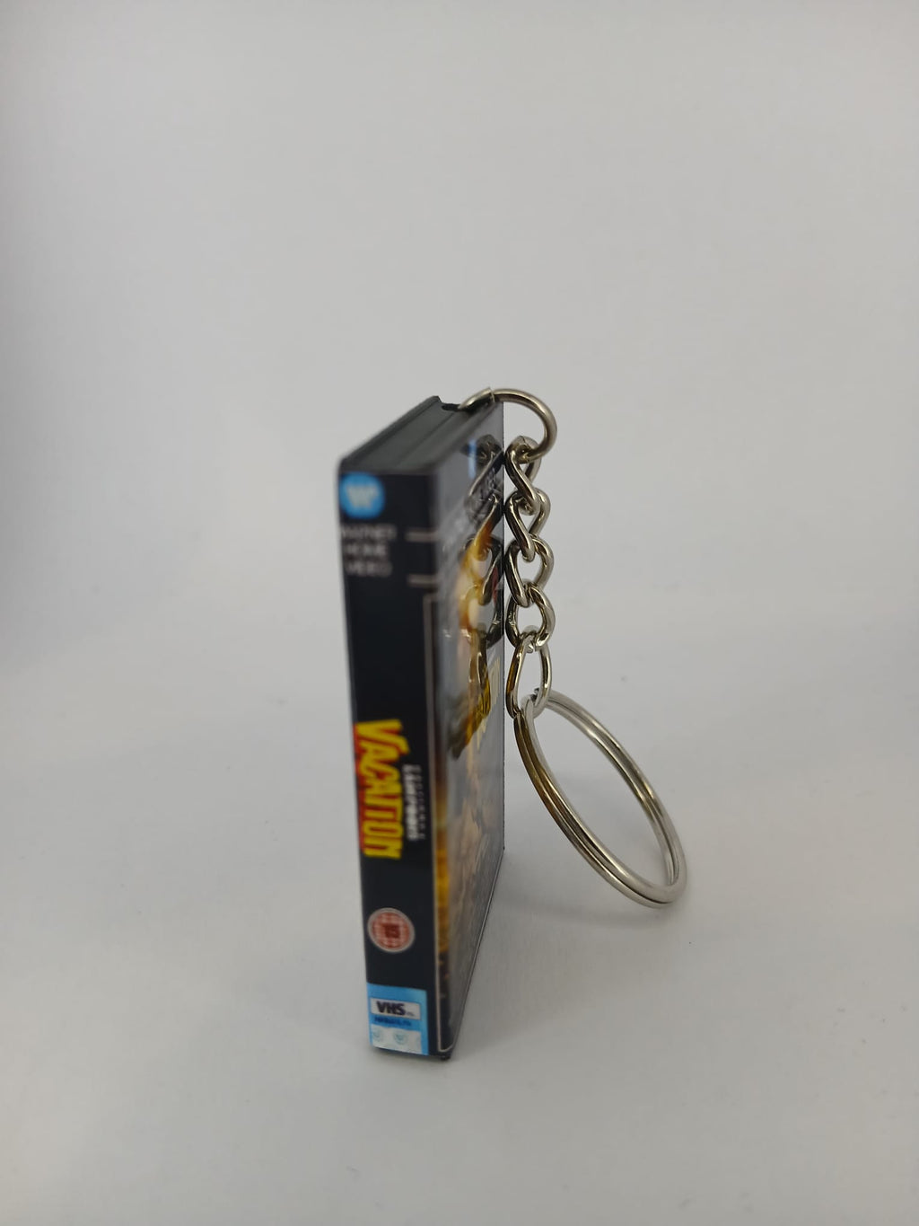 National Lampoon's Vacation VHS keyring — front cover standing angled