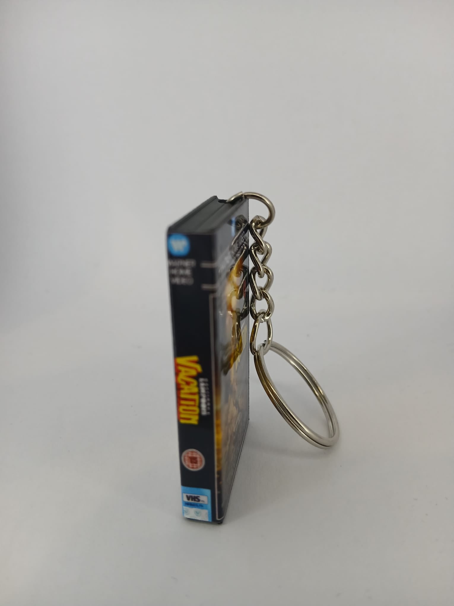 National Lampoon's Vacation VHS keyring — front cover standing angled