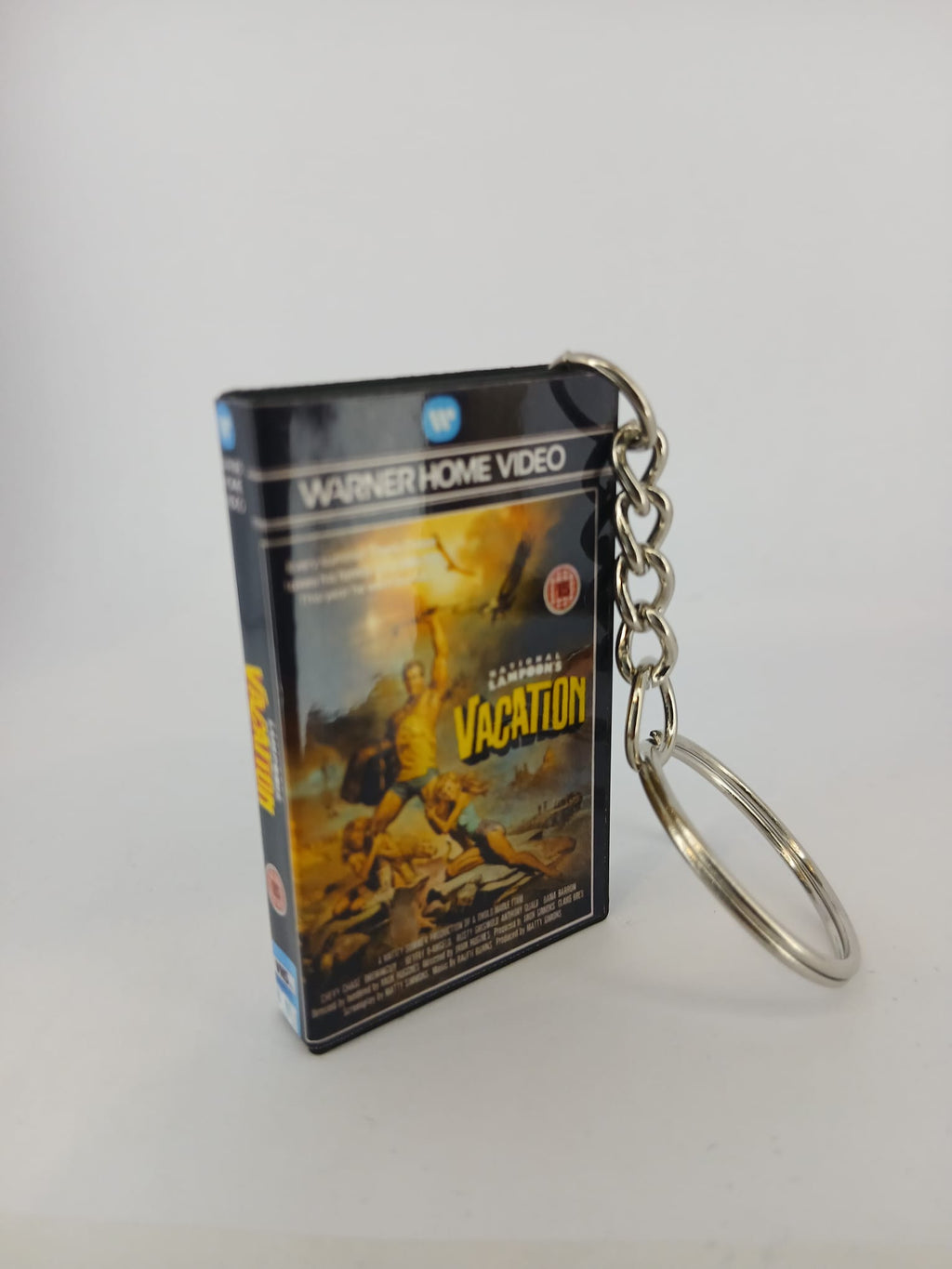 National Lampoon's Vacation VHS keyring — front cover standing angled 2