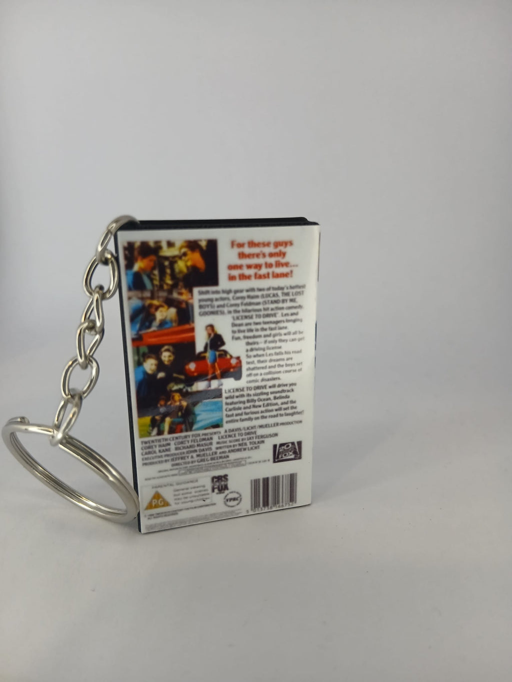 Licence to Drive VHS keyring — back and spine angled view