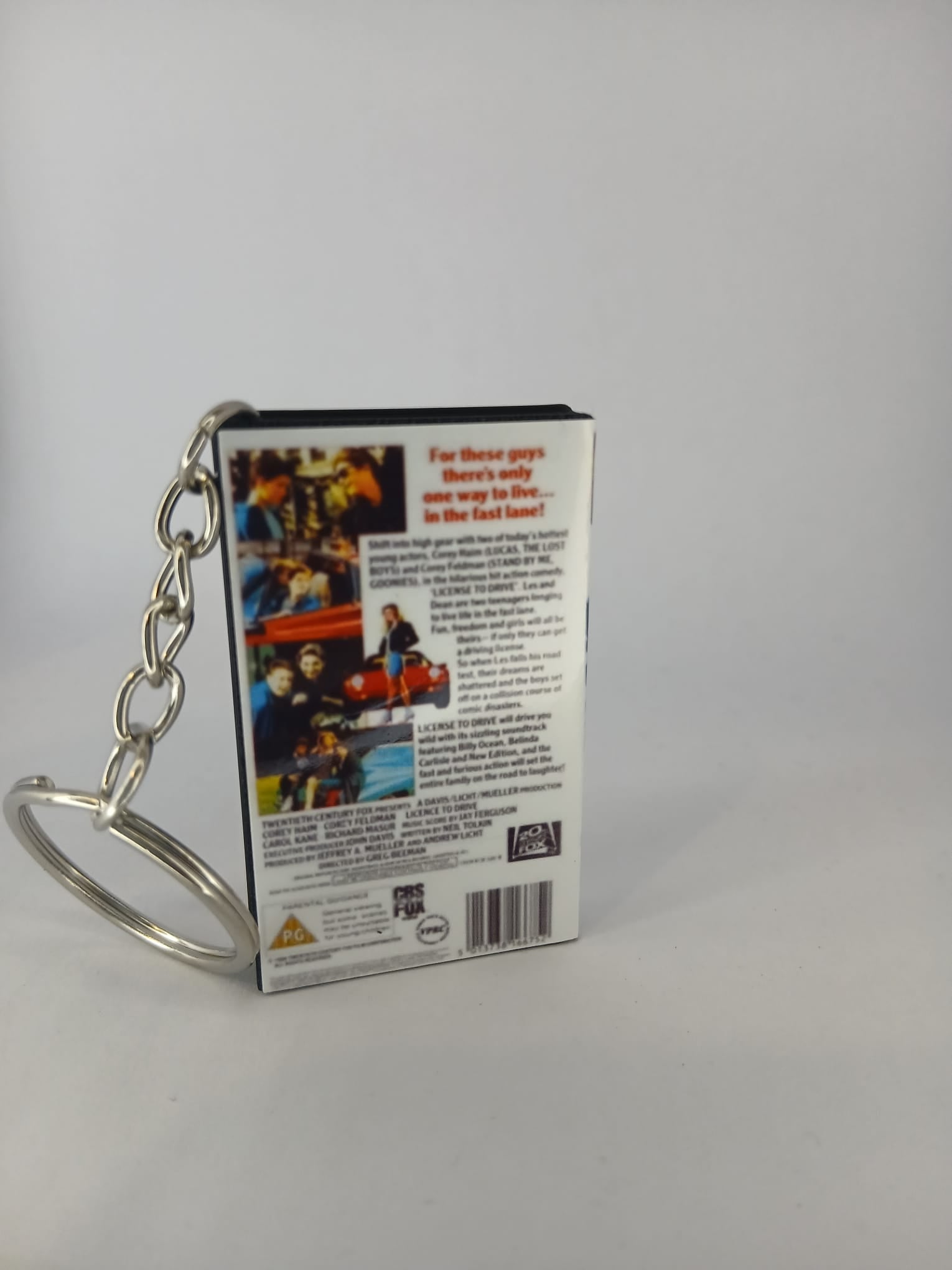Licence to Drive VHS keyring — back and spine angled view
