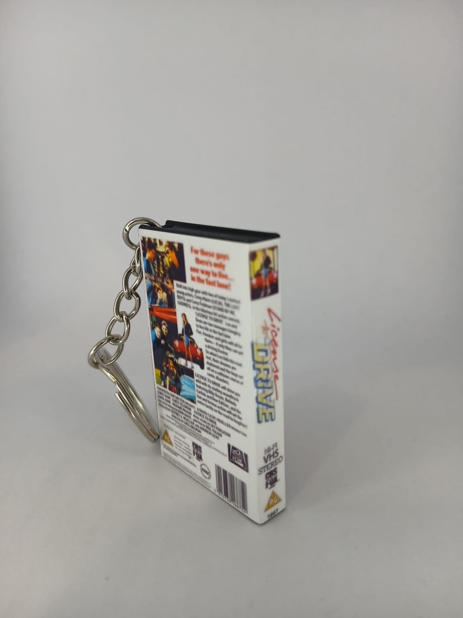 Licence to Drive VHS keyring — front cover flat lay angled