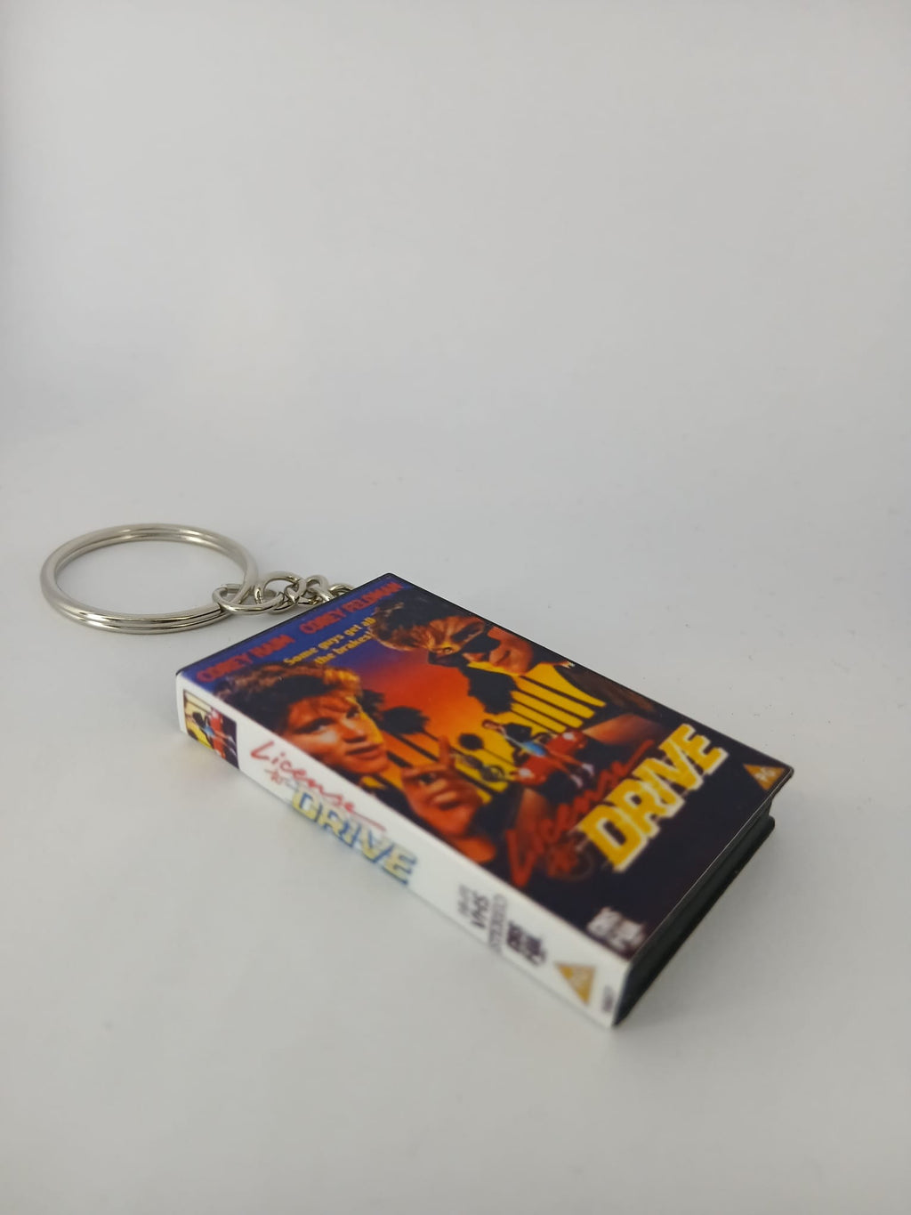 Licence to Drive VHS keyring — front cover standing angled
