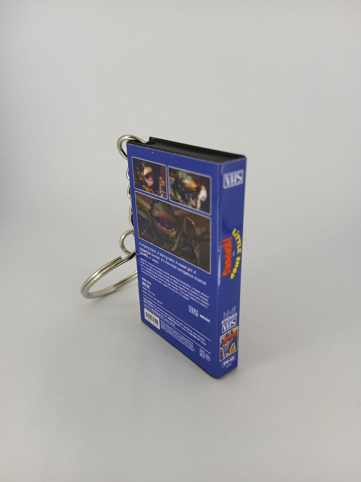 Little Shop of Horrors VHS keyring — front and spine angled view