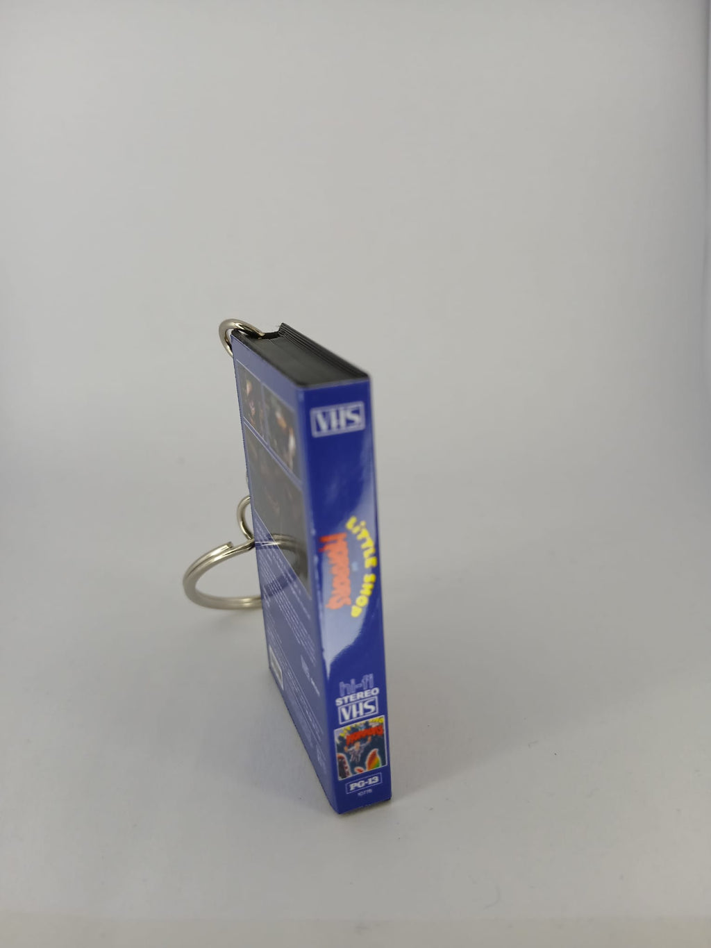Little Shop of Horrors VHS keyring — front cover standing angled