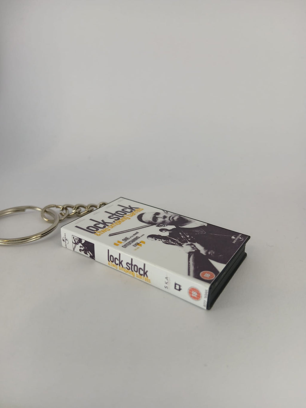 Lock, Stock and Two Smoking Barrels Mini VHS Keyring – flat lay side angle