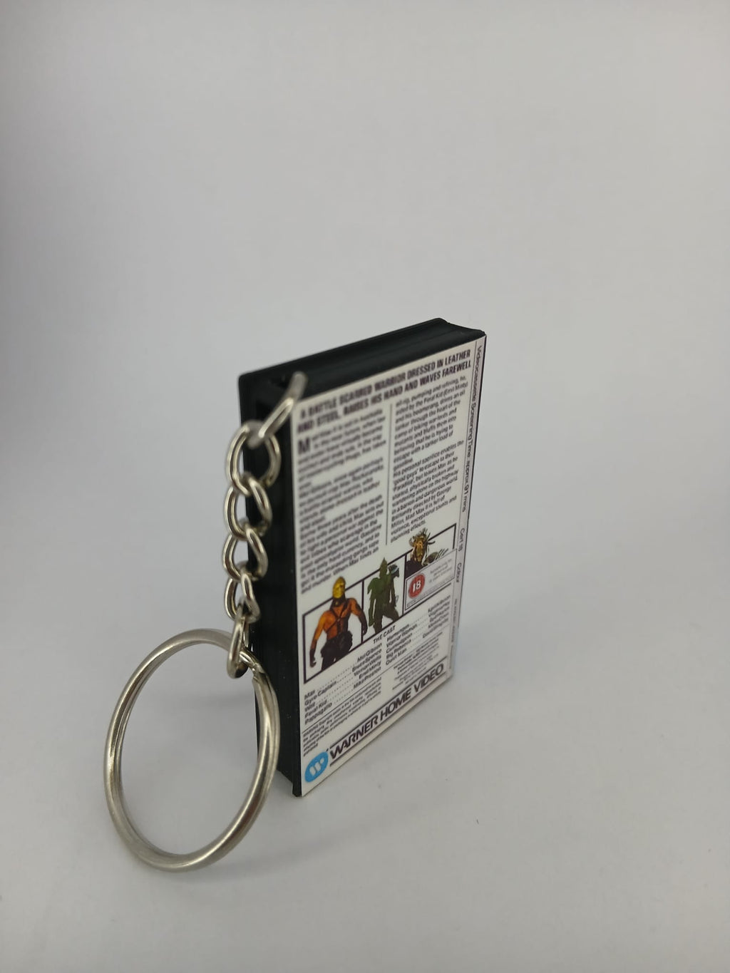 Mad Max 2 VHS keyring — back and spine angled view standing
