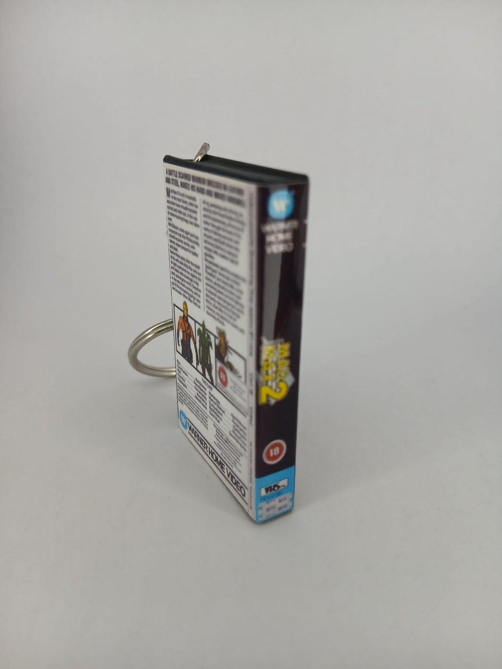 Mad Max 2 VHS keyring — front cover flat lay angled