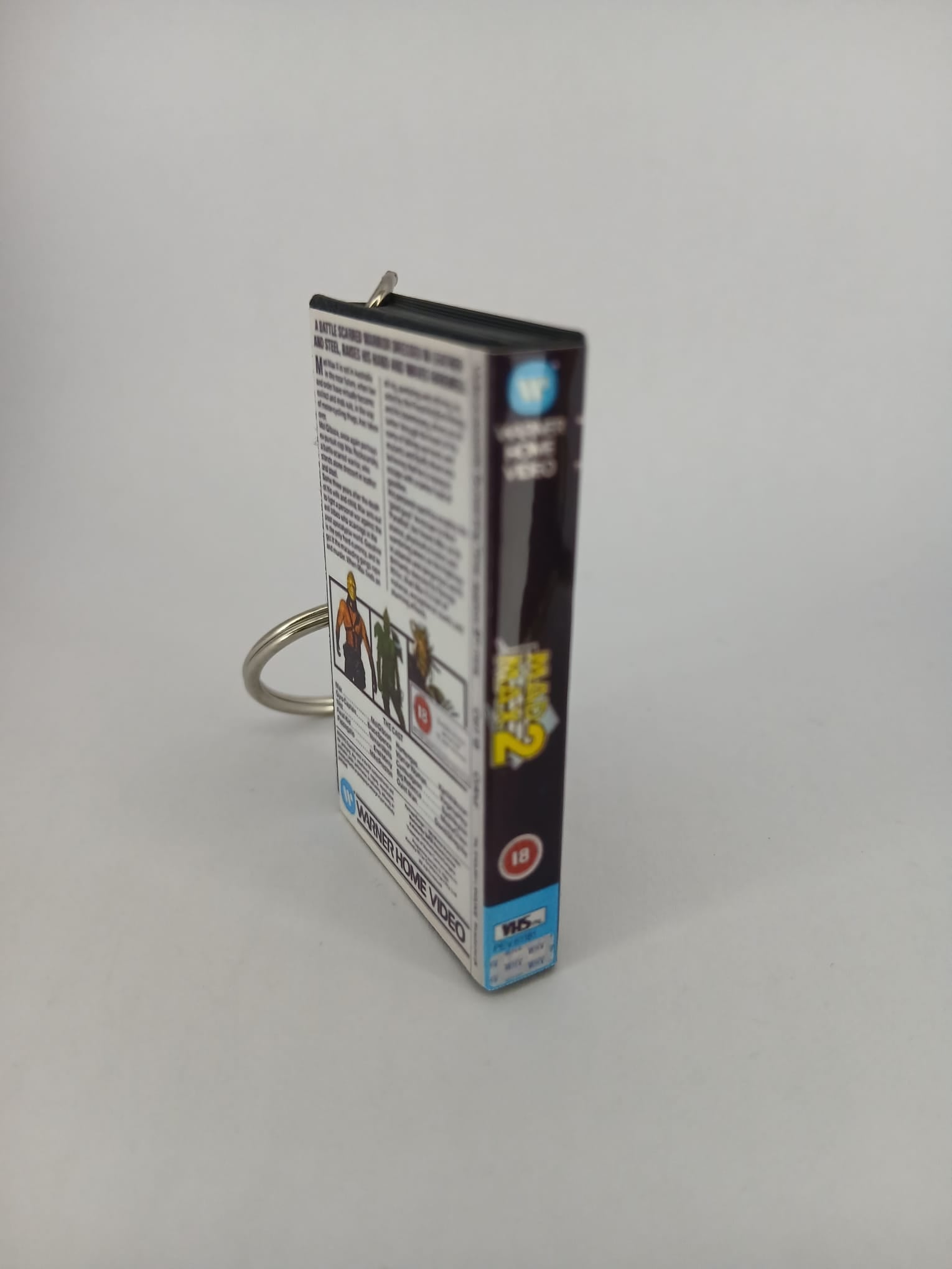 Mad Max 2 VHS keyring — front cover flat lay angled