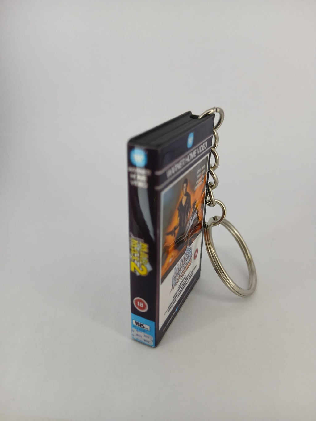 Mad Max 2 VHS keyring — front cover standing angled