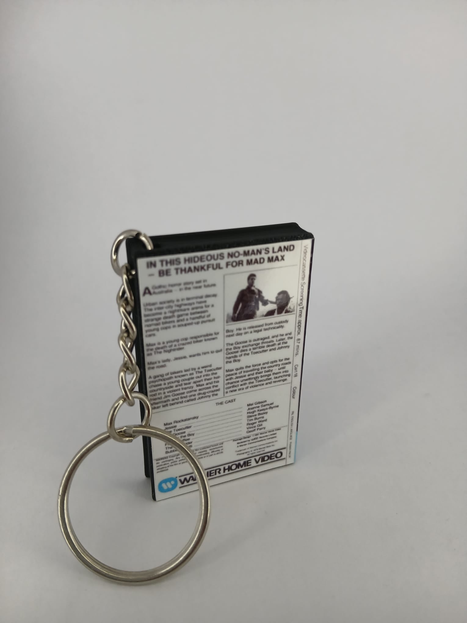 Mad Max VHS keyring — spine view standing