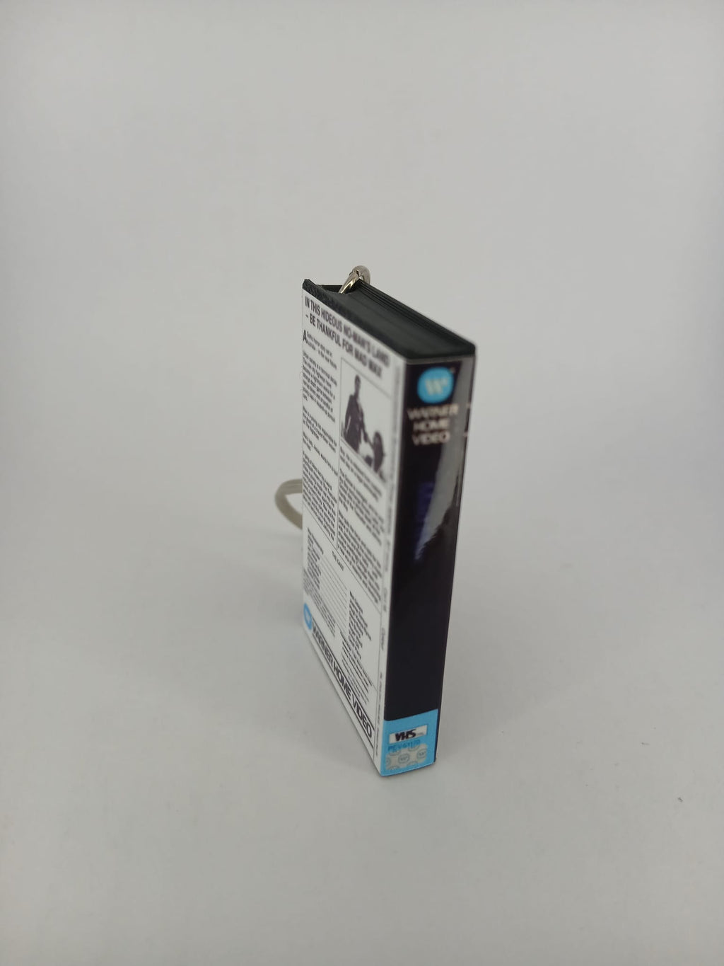 Mad Max VHS keyring — front cover standing angled