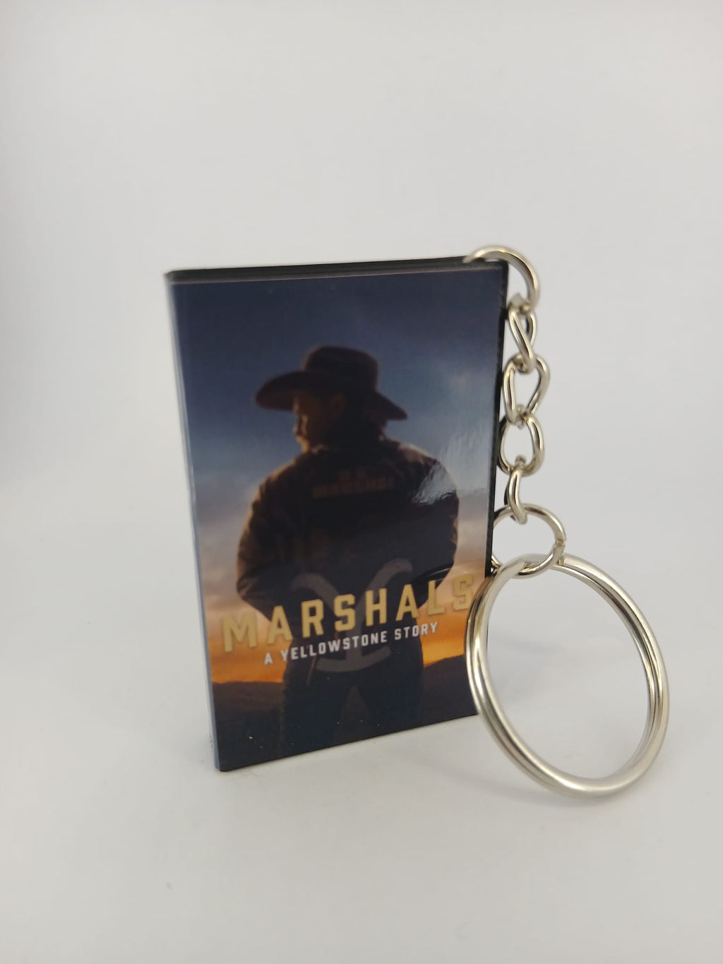Marshals: A Yellowstone Story VHS keyring — front cover standing with coin for scale
