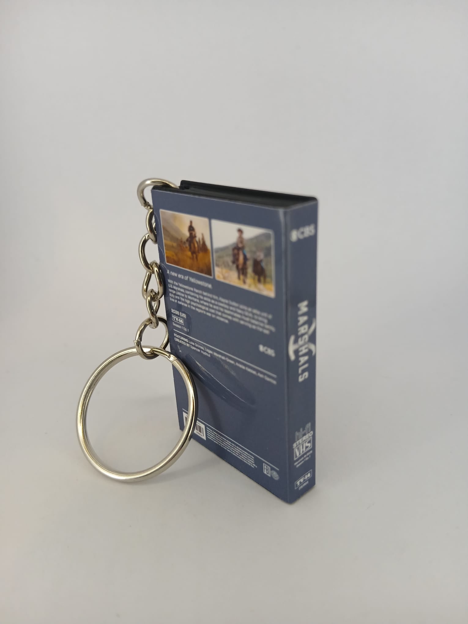 Marshals: A Yellowstone Story VHS keyring — front and spine flat lay angled