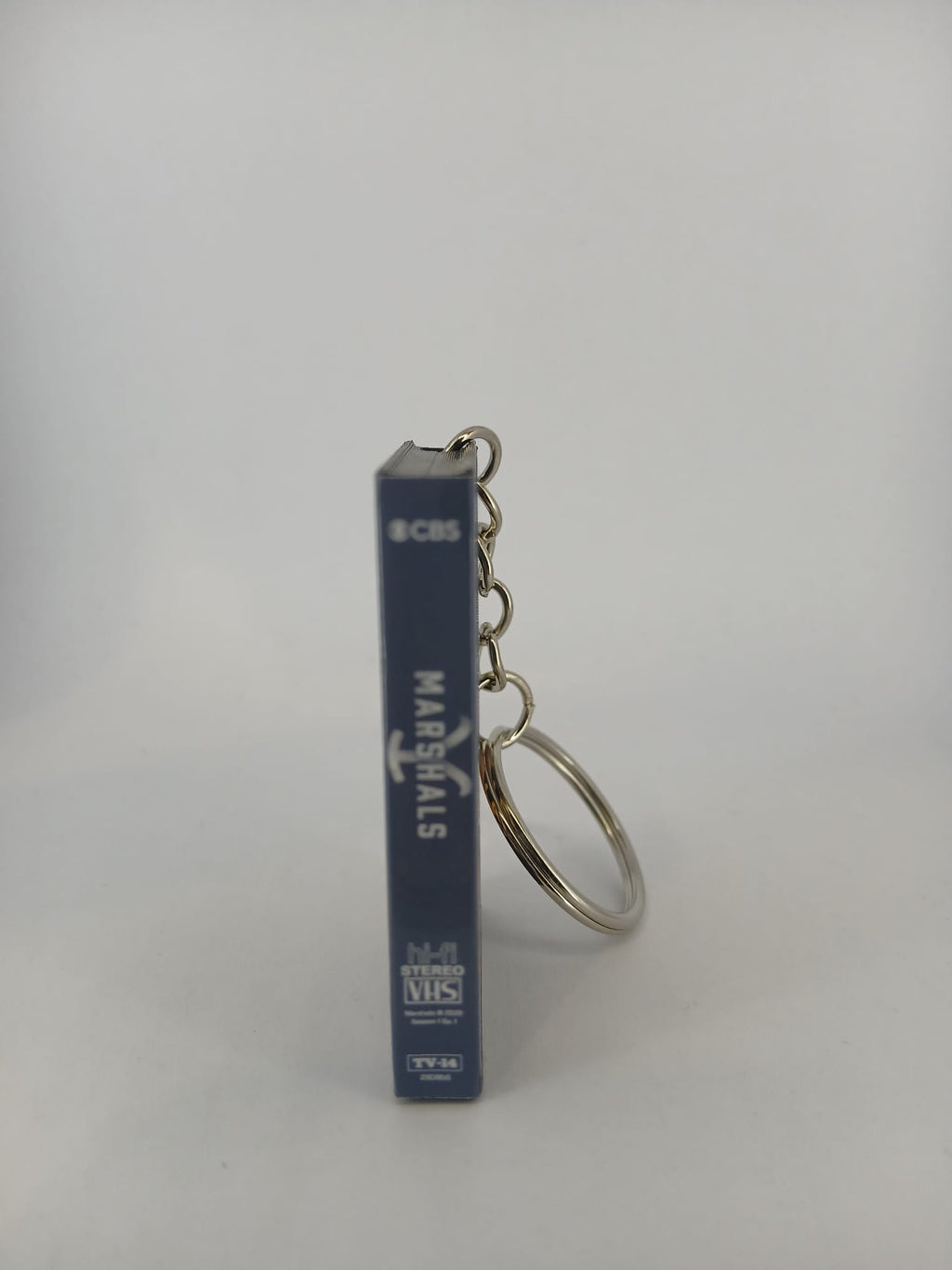 Marshals: A Yellowstone Story VHS keyring — front and spine flat lay angled 2