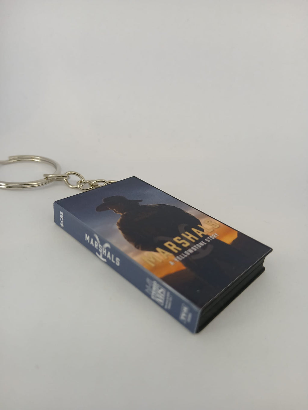Marshals: A Yellowstone Story VHS keyring — front cover flat lay angled