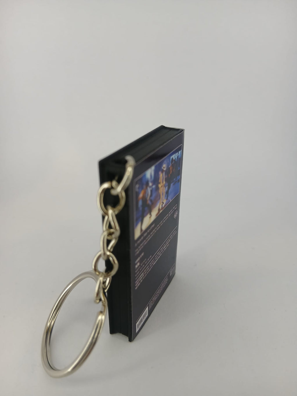 Moonwalker VHS keyring — back cover angled view standing