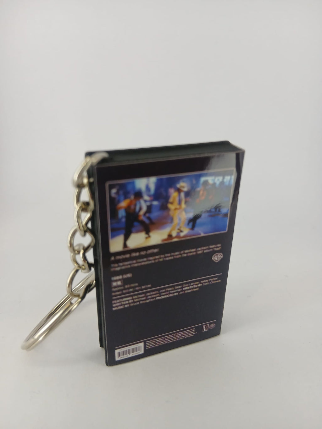 Moonwalker VHS keyring — front and spine angled view standing