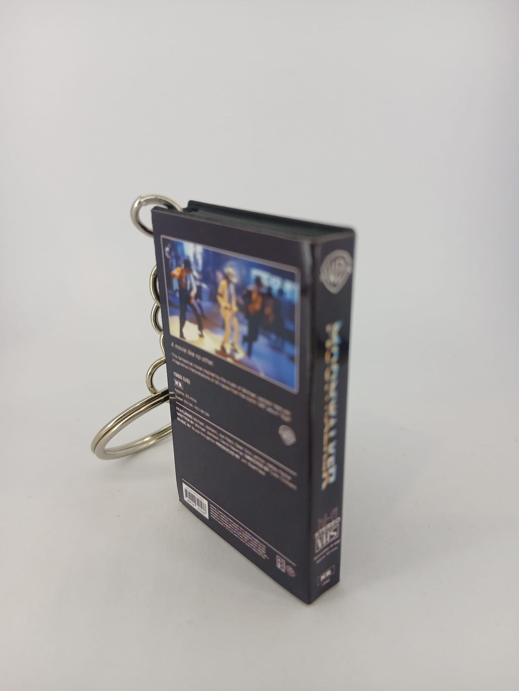 Moonwalker VHS keyring — front cover standing angled