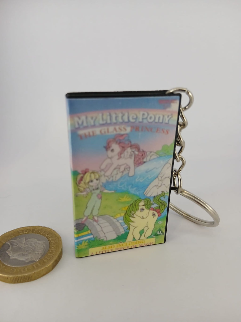 My Little Pony VHS keyring — front cover standing with coin for scale