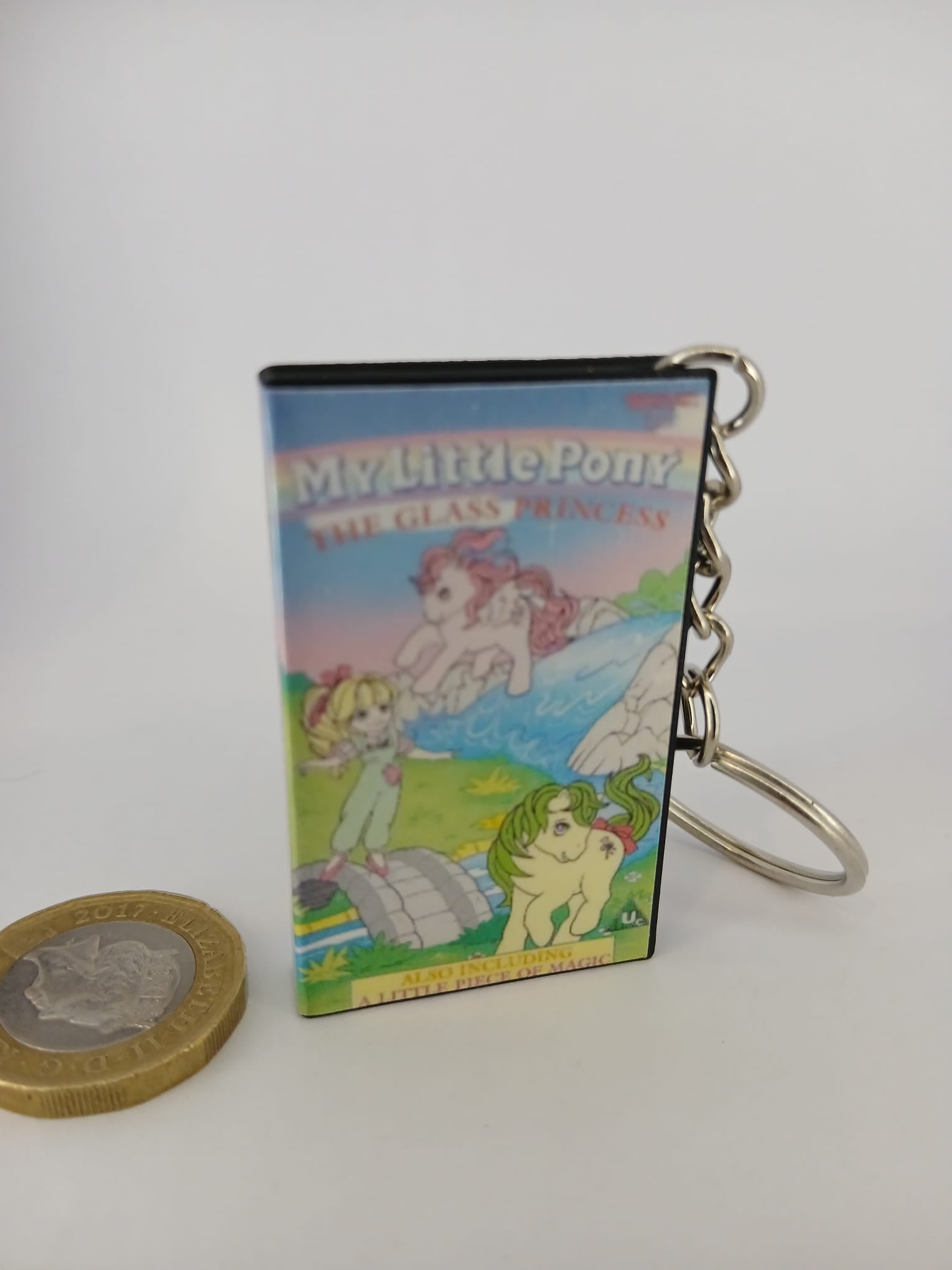 My Little Pony VHS keyring — front cover standing with coin for scale