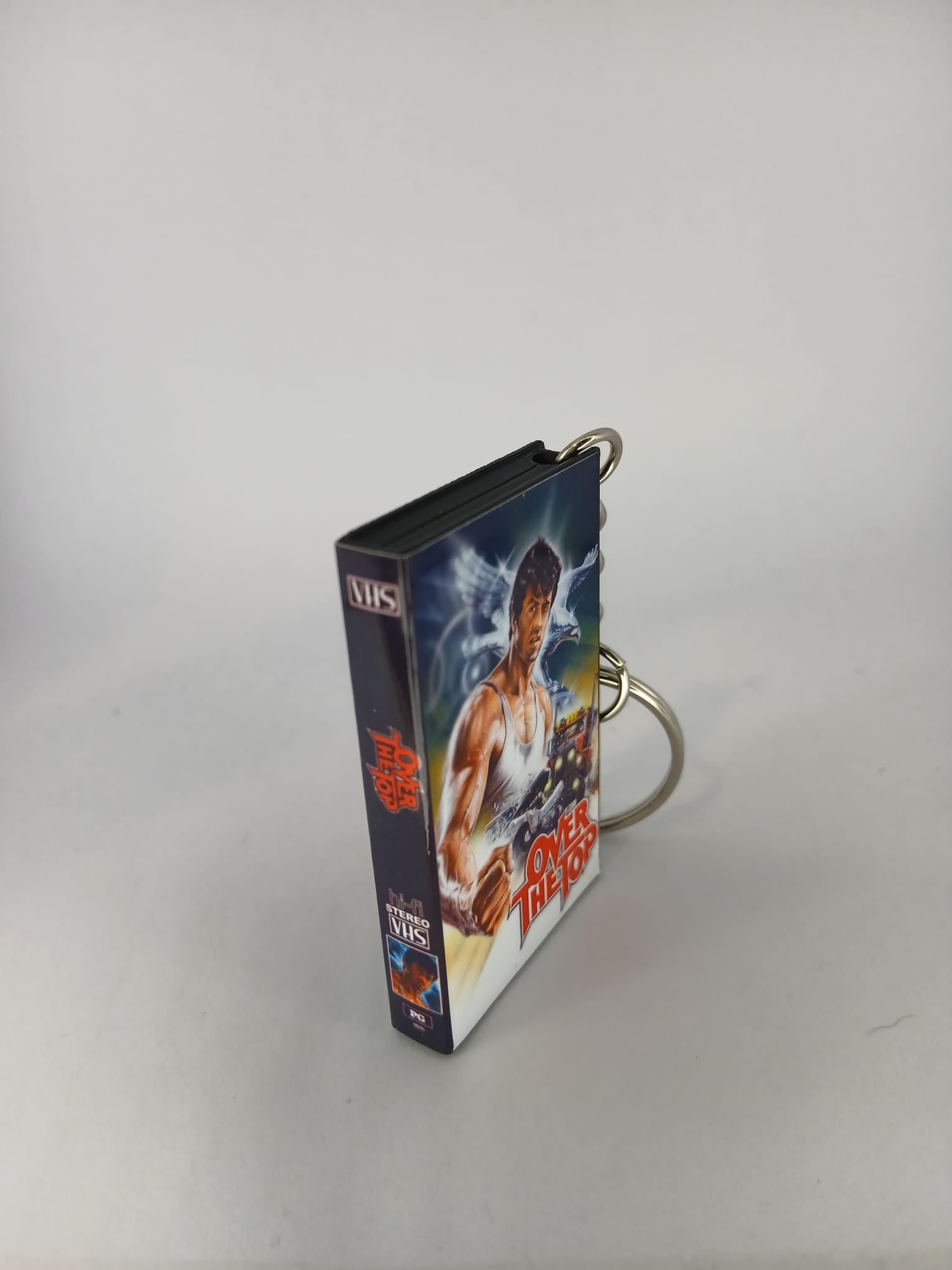 Over the Top VHS keyring — front cover with coin for scale