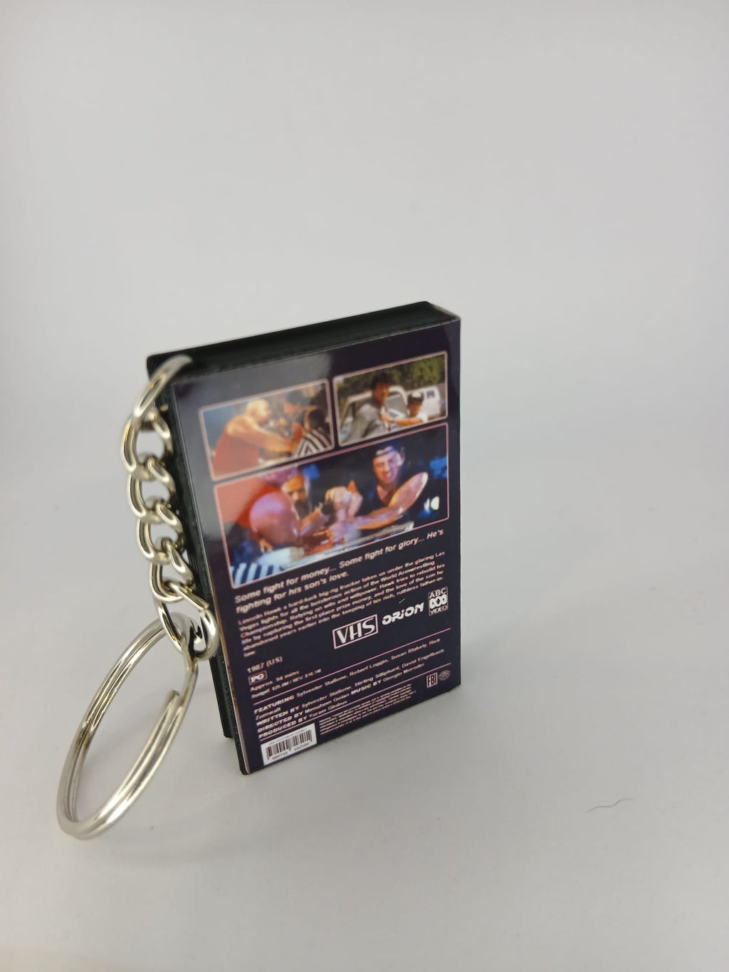 Over the Top VHS keyring — flat lay angled view