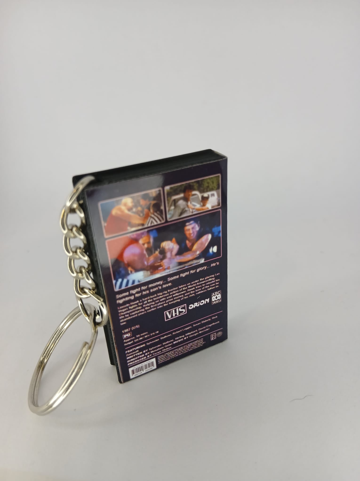 Over the Top VHS keyring — flat lay angled view