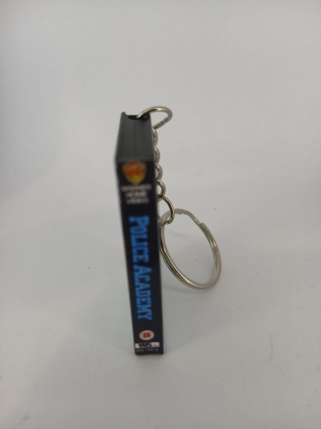 Police Academy VHS keyring — back cover angled view standing