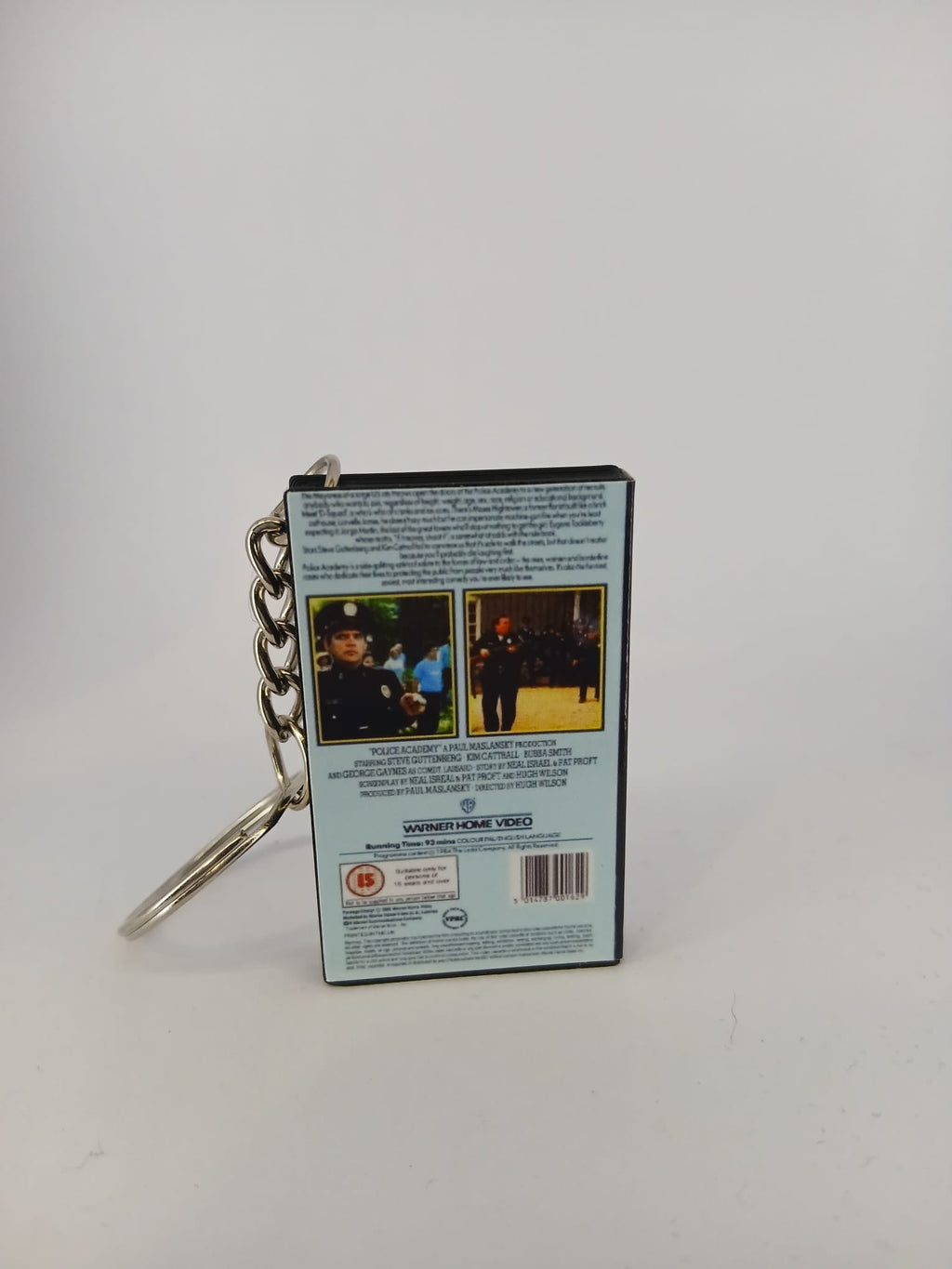 Police Academy VHS keyring — flat lay front and spine angled