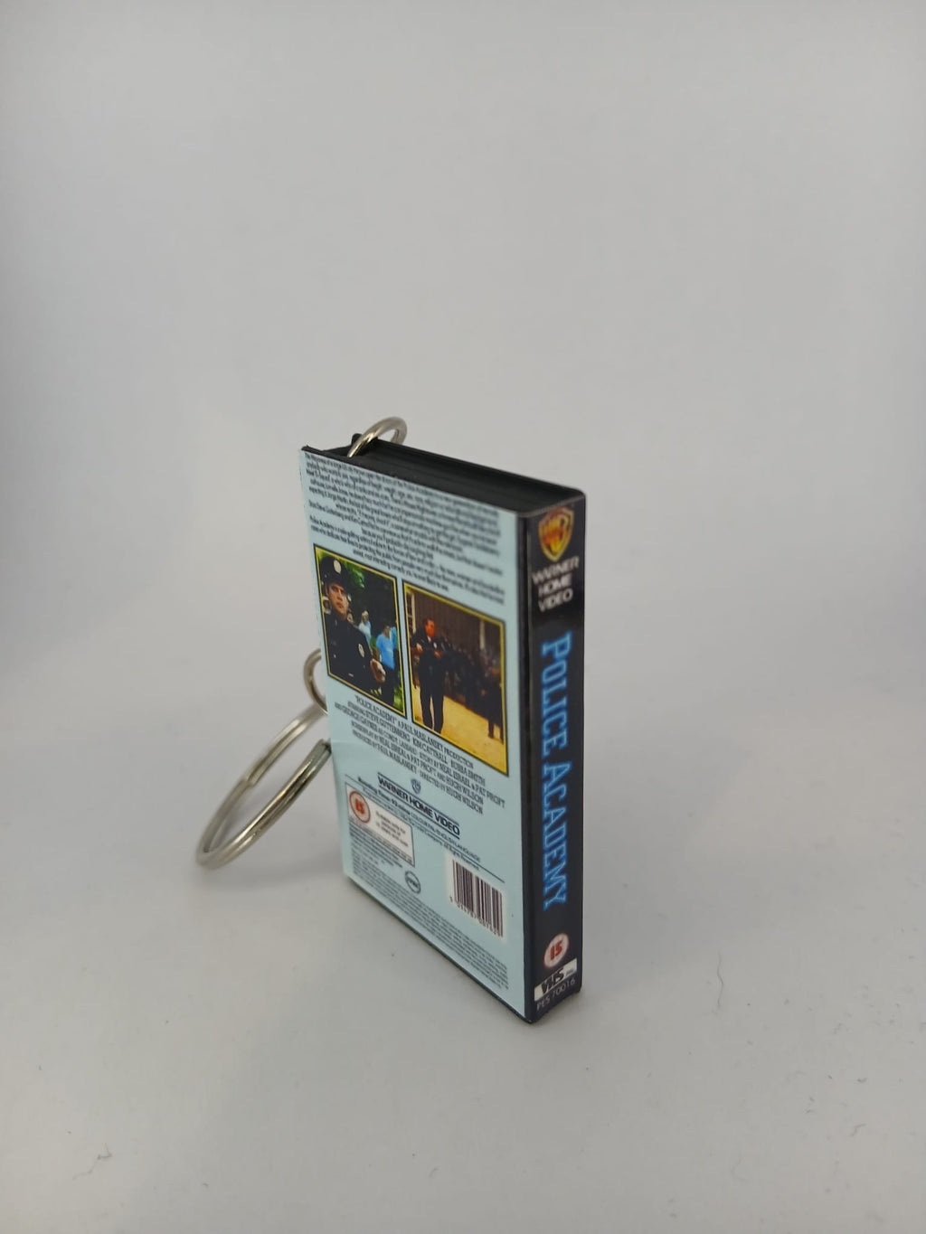 Police Academy VHS keyring — spine and front angled view standing