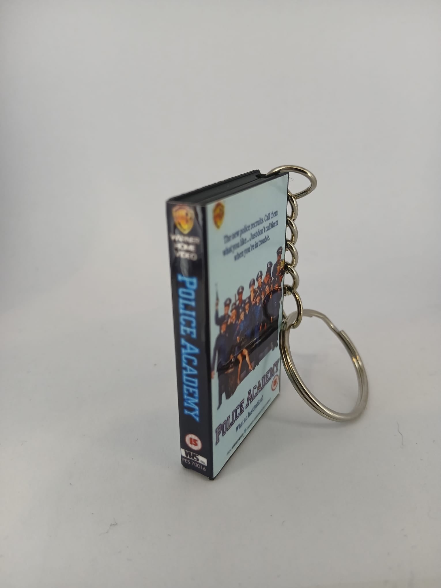 Police Academy VHS keyring — front cover standing angled 2