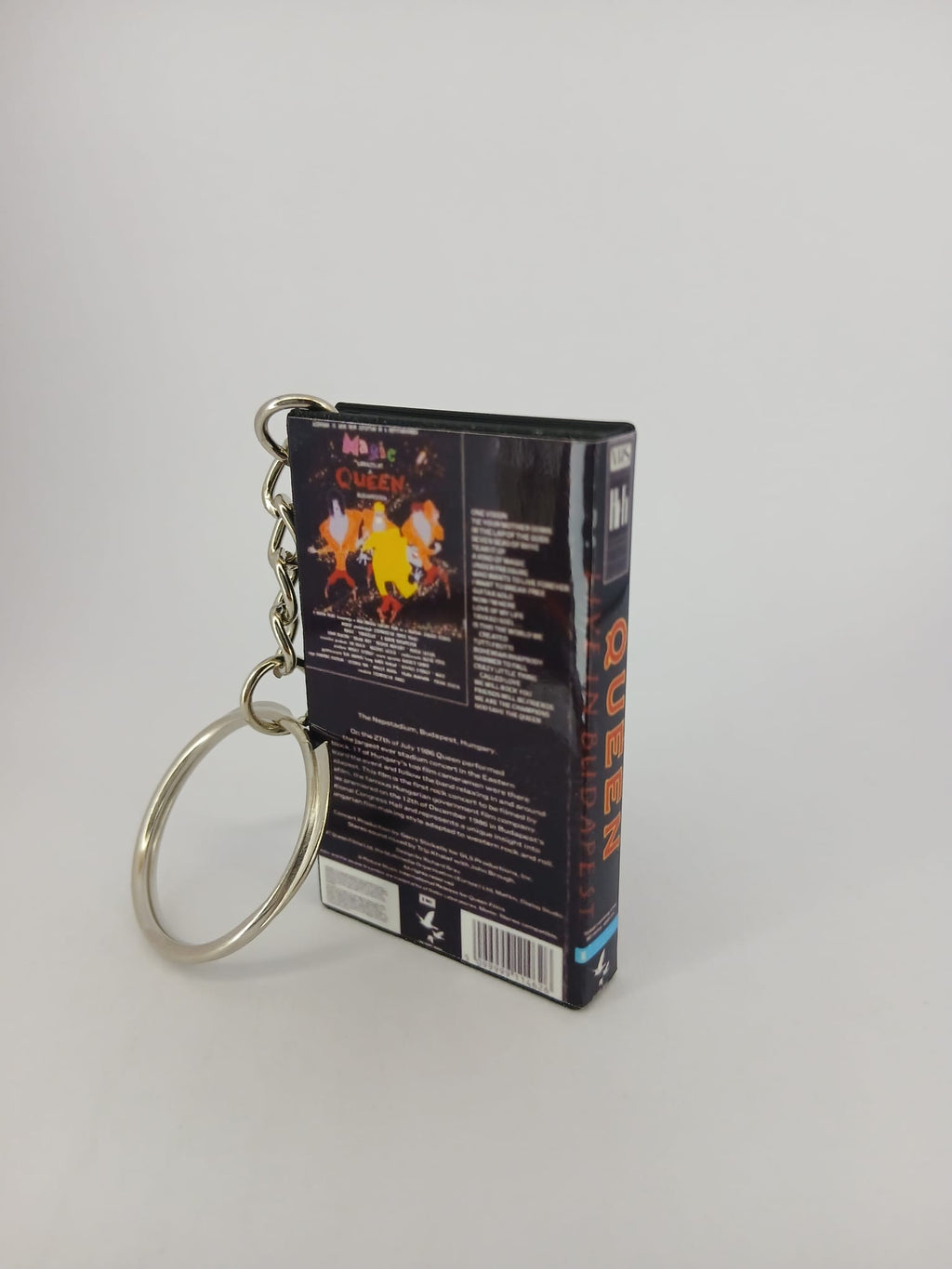 Queen Live in Budapest VHS keyring — front and spine angled view standing