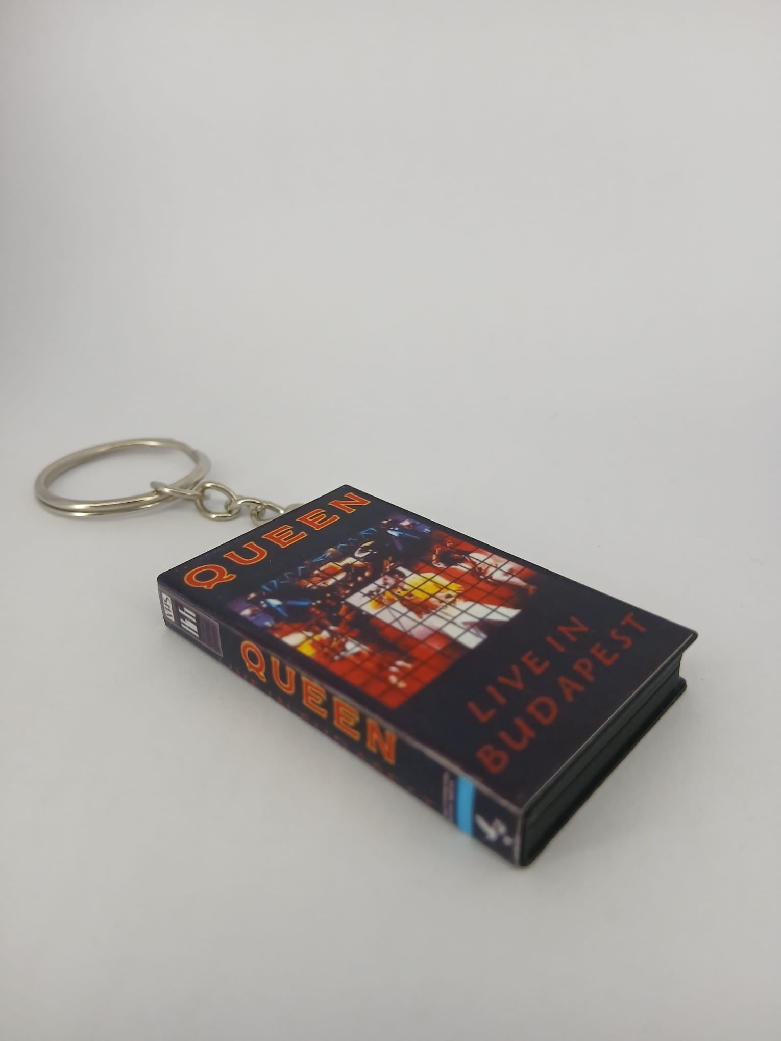 Queen Live in Budapest VHS keyring — front cover standing angled