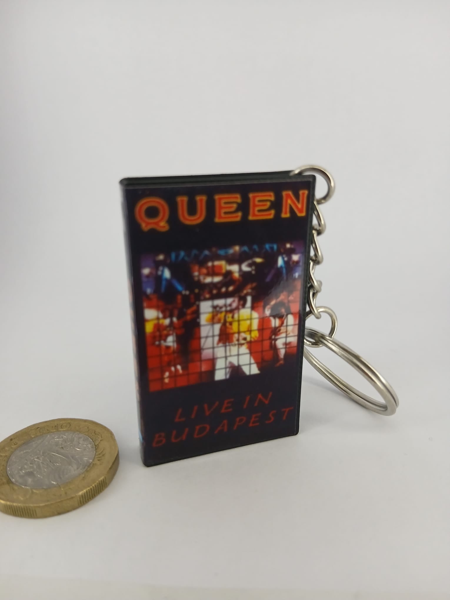 Queen Live in Budapest VHS keyring — front cover standing with coin for scale
