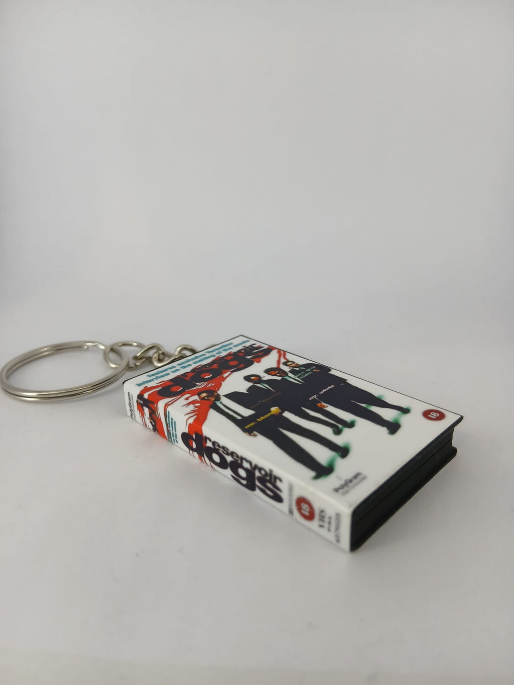 Reservoir Dogs VHS keyring — front and spine angled view standing