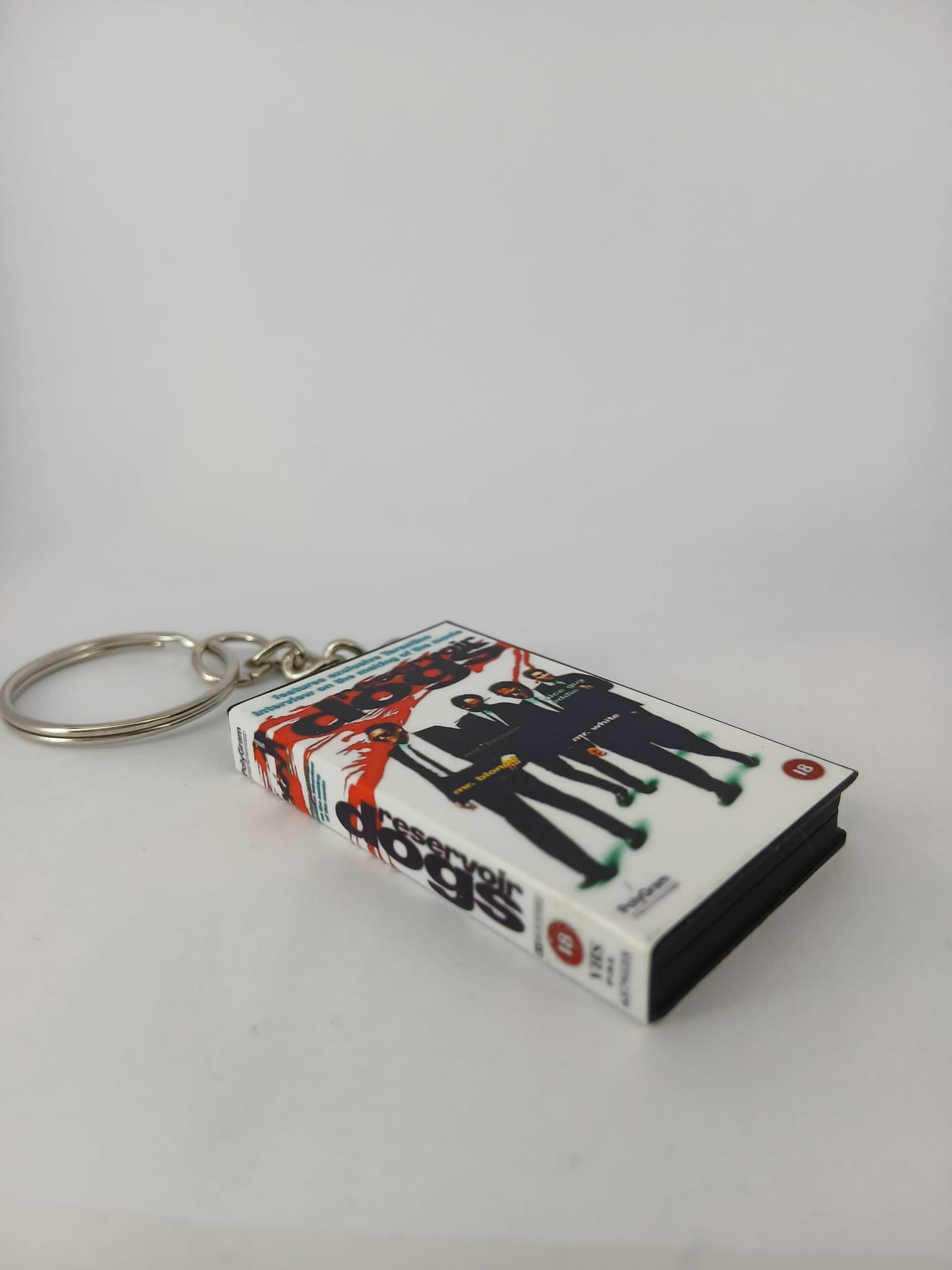 Reservoir Dogs VHS keyring — front and spine angled view standing