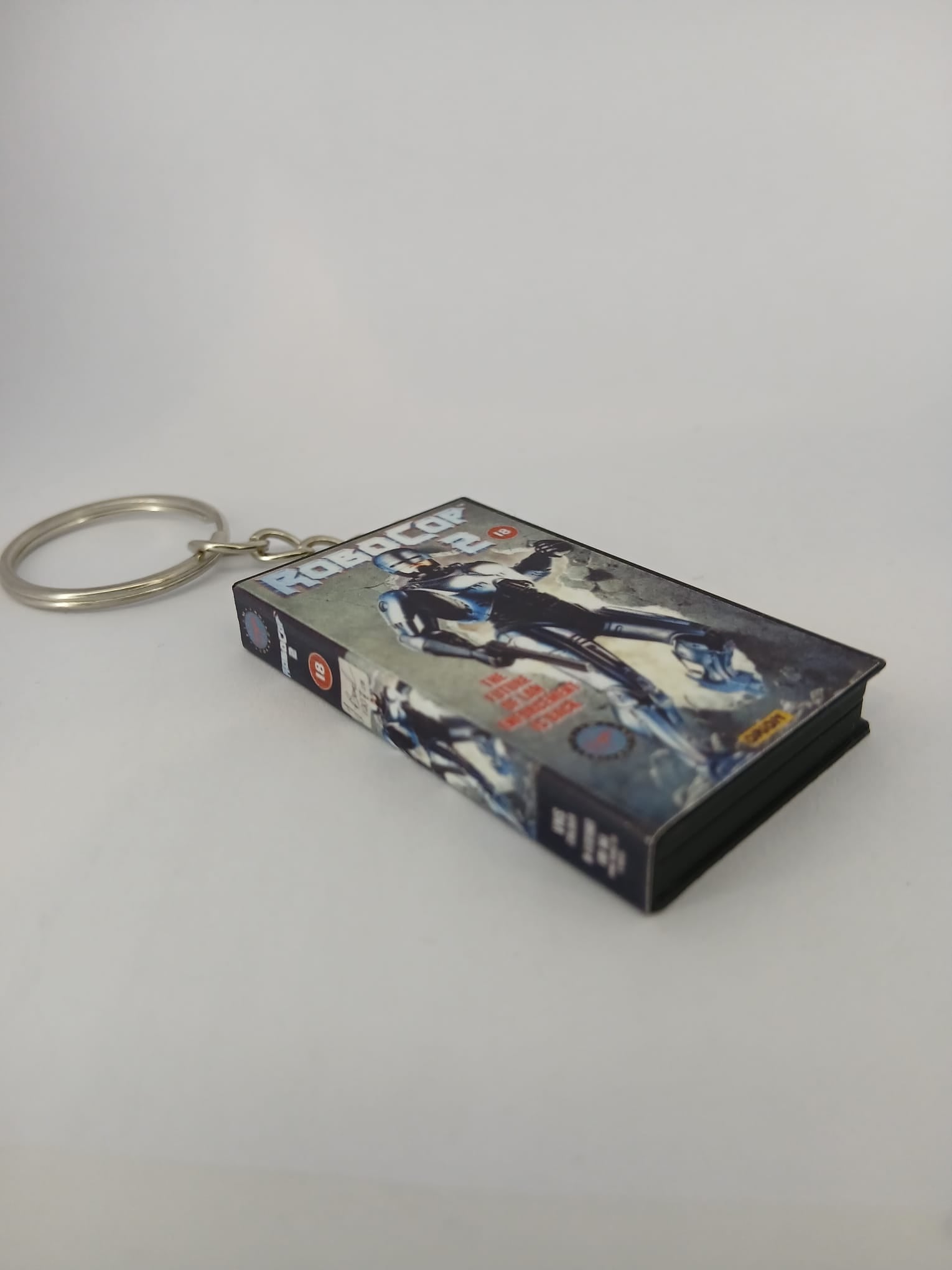 RoboCop 2 VHS keyring — front cover flat lay angled