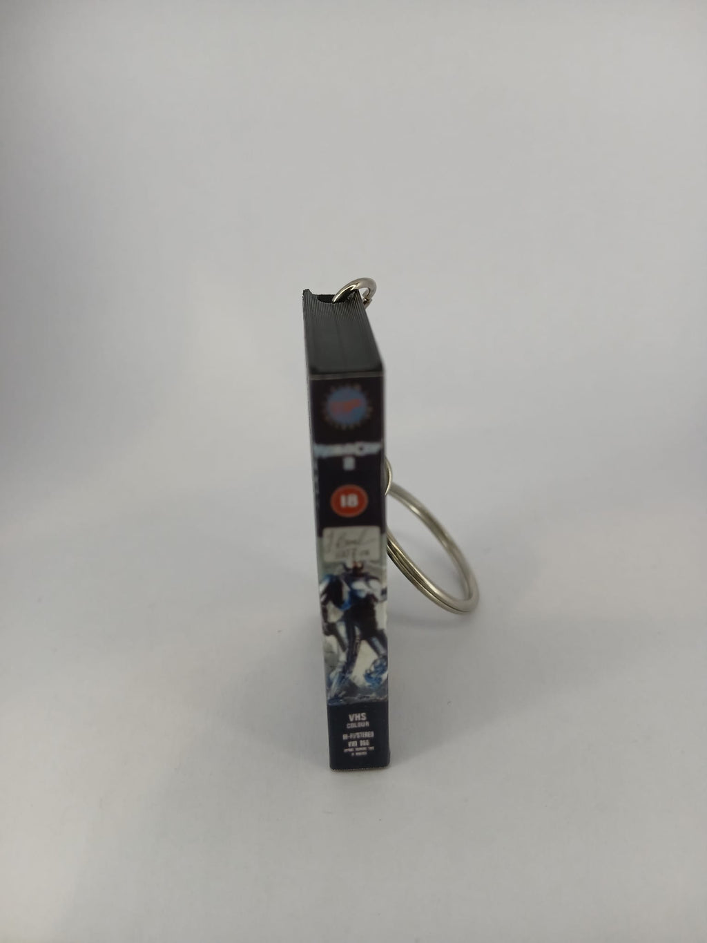 RoboCop 2 VHS keyring — front cover standing angled
