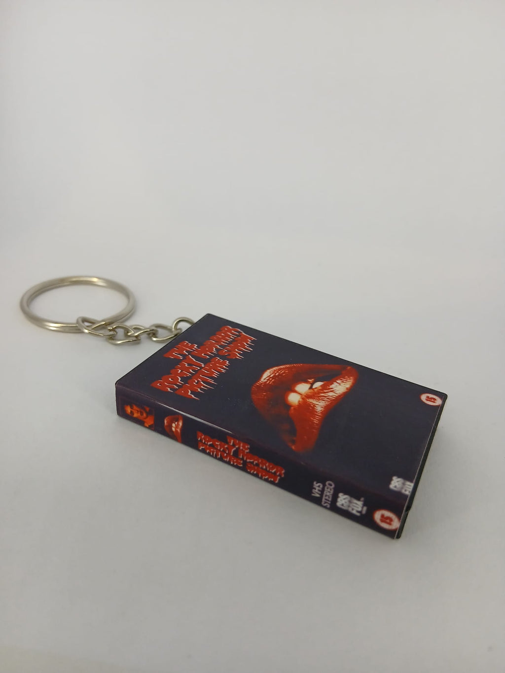 The Rocky Horror Picture Show VHS keyring — front cover standing angled